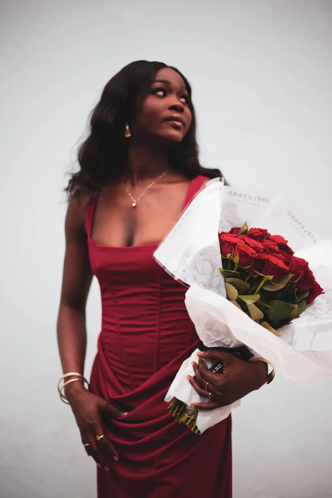 Model Grace with red roses, studio shot for her model book