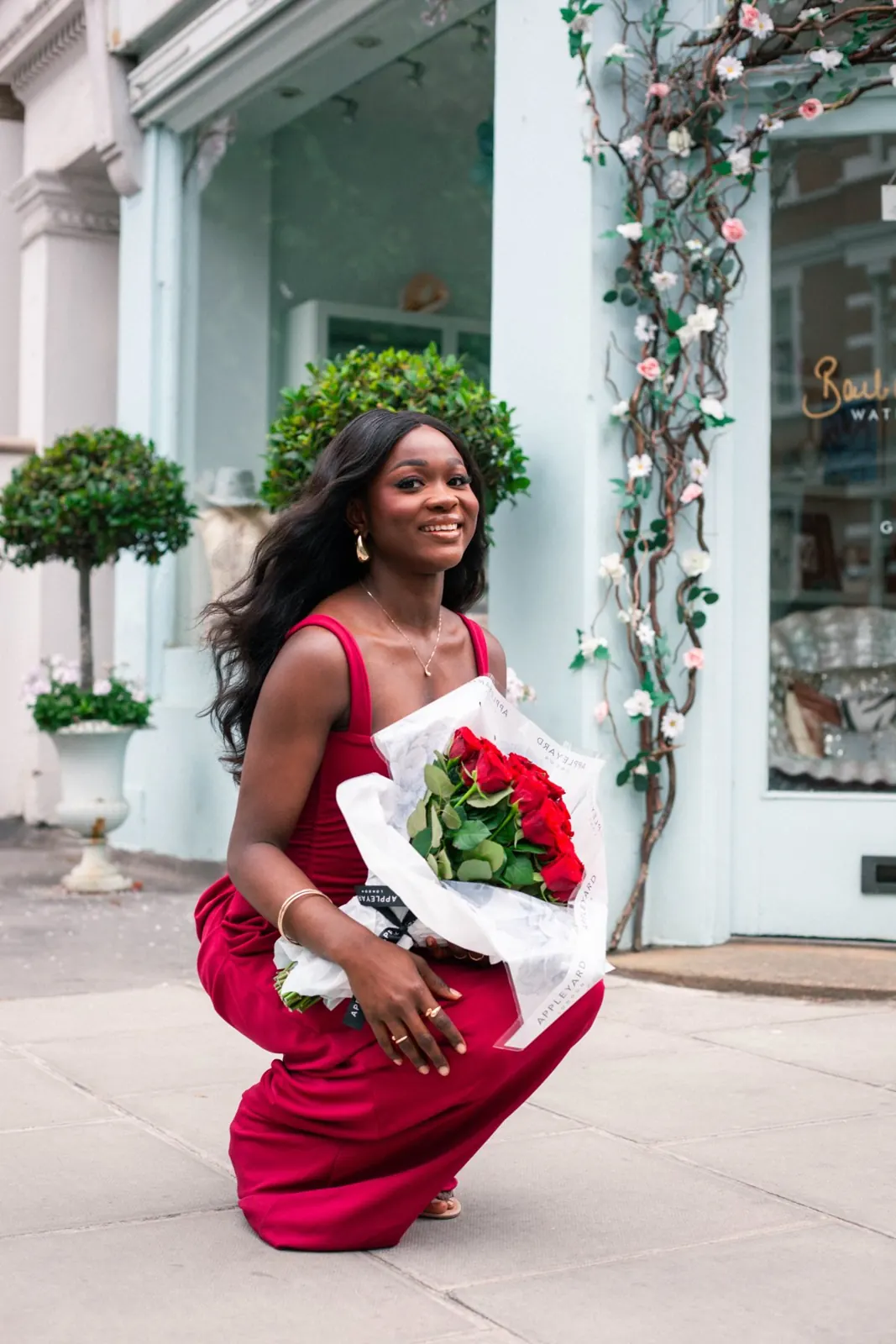 Model Grace with roses outside a Chelsea shop, model book
